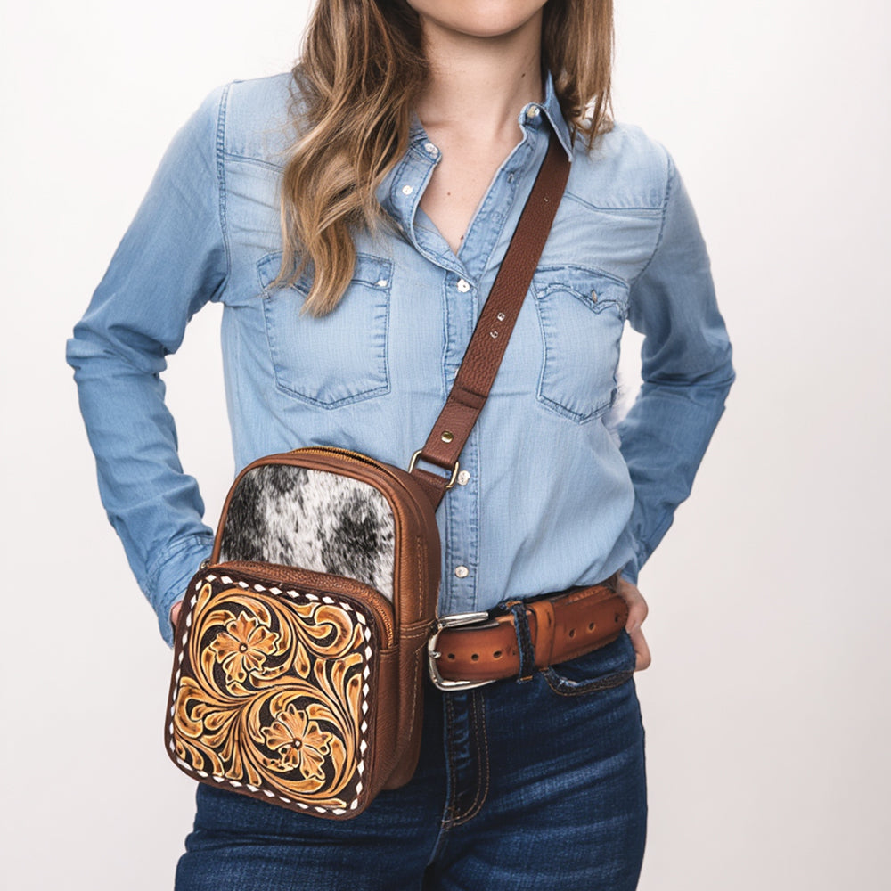 ADBGA654 Tooled Leather & Cowhide Sling Bag with Floral Front Pocket and Whipstitch Trim